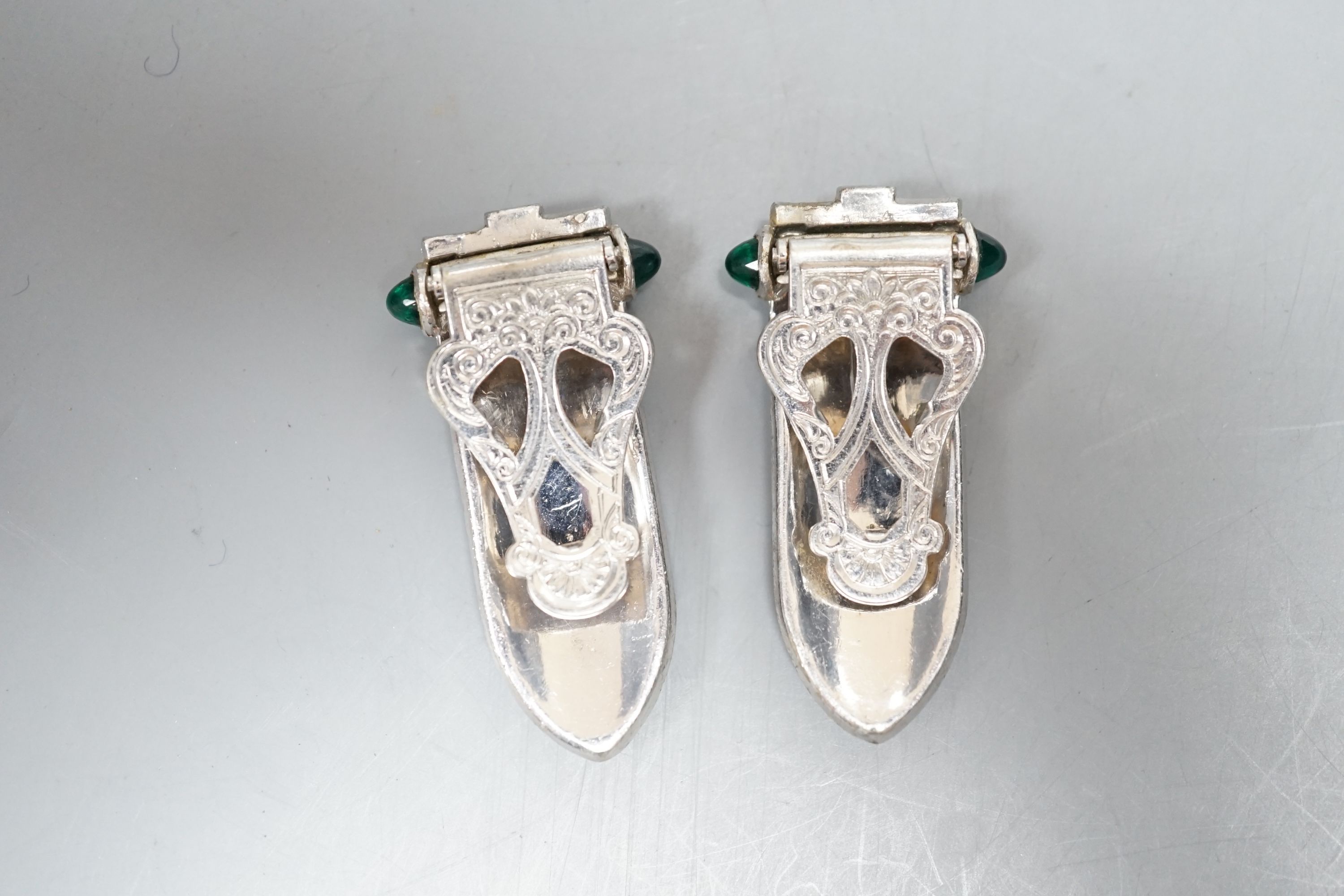 A pair of art deco paste clip earrings and a sterling bangle.